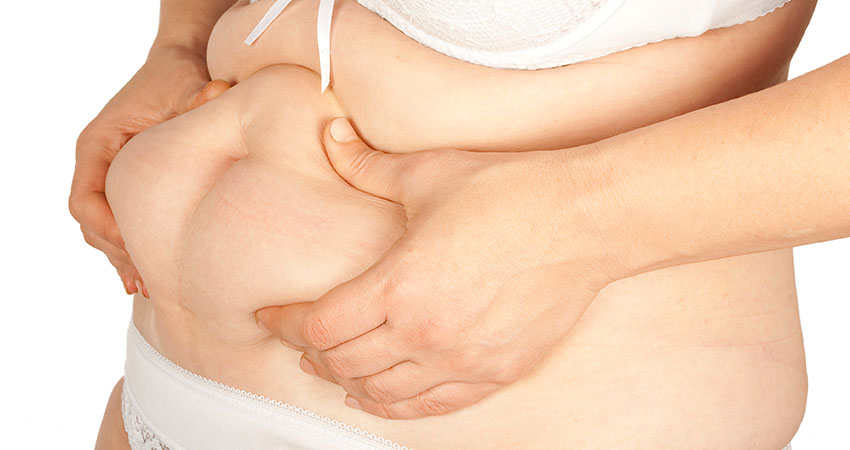 Fat woman pinching her fat tummy